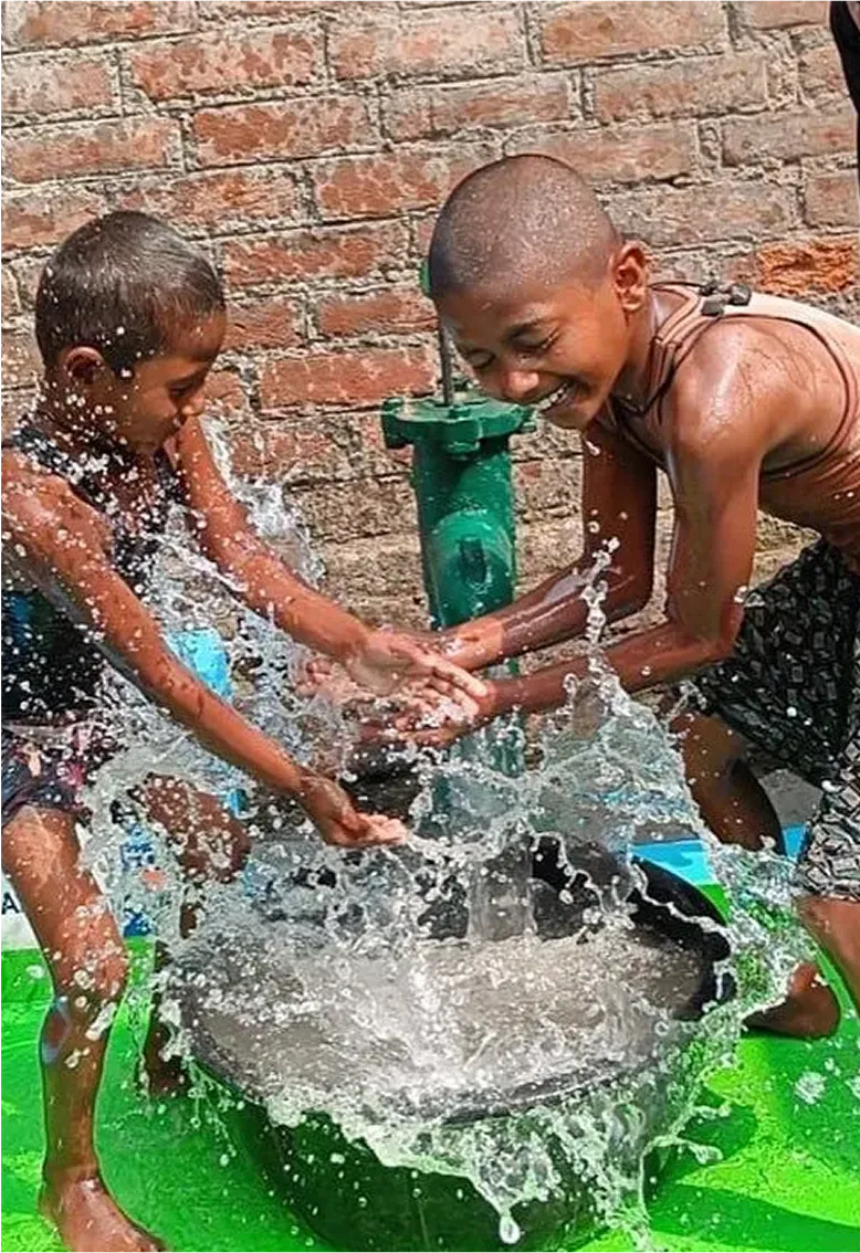 Children happily playing with water.