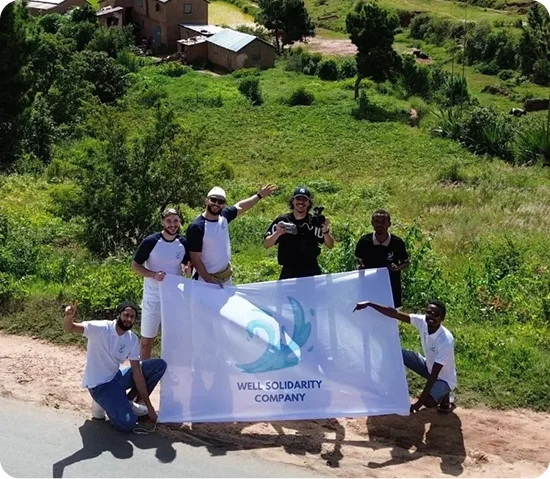 Group holding a Well & Trees Company banner.