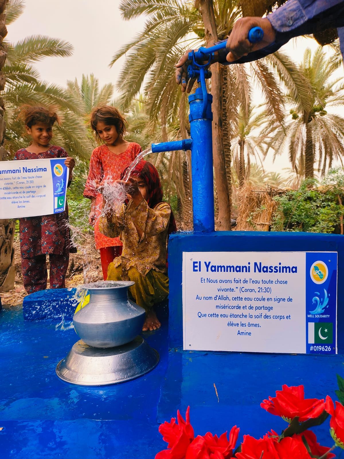 Children using a water pump.